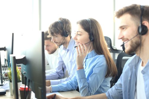 Portrait,Of,Call,Center,Worker,Accompanied,By,Her,Team.,Smiling
